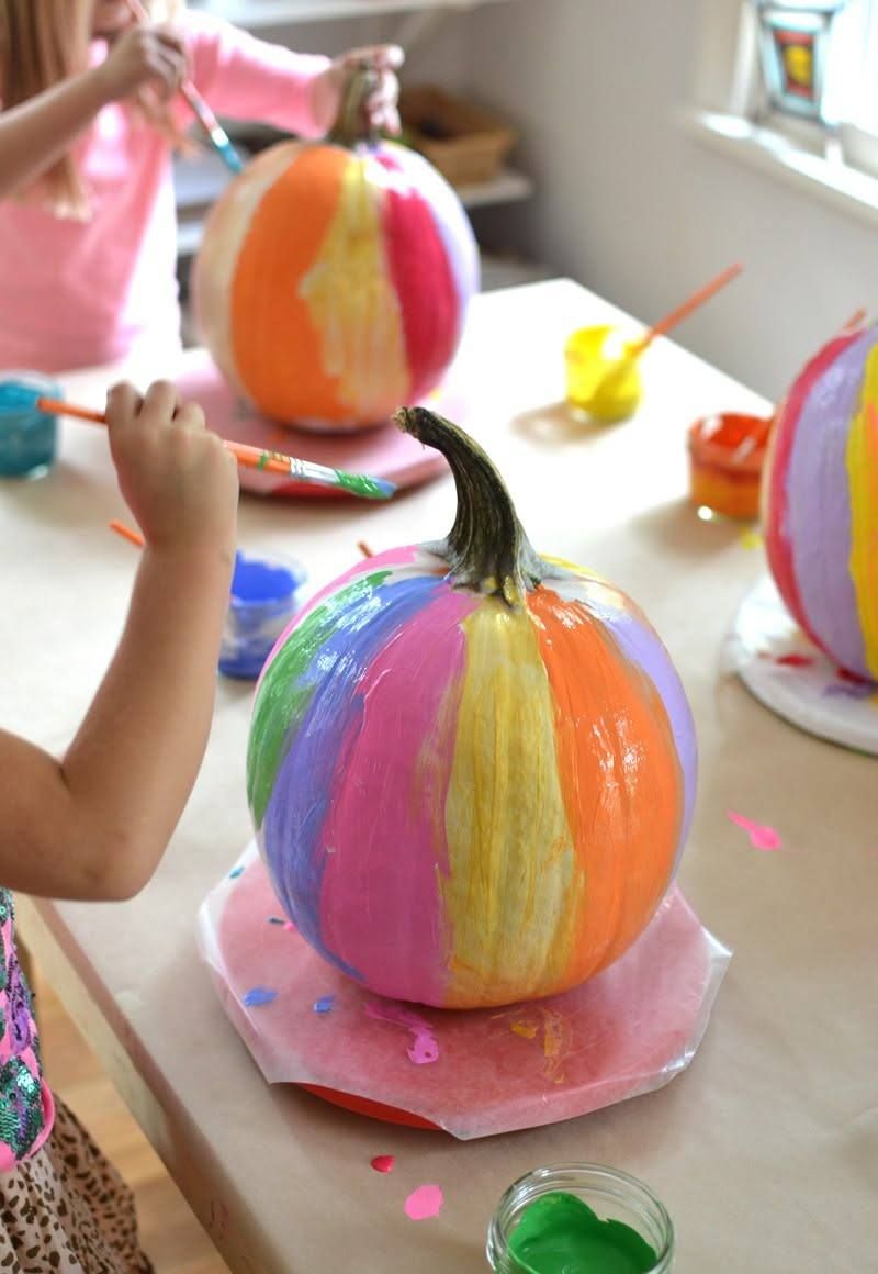 Brightly painted rainbow pumpkins on the art table