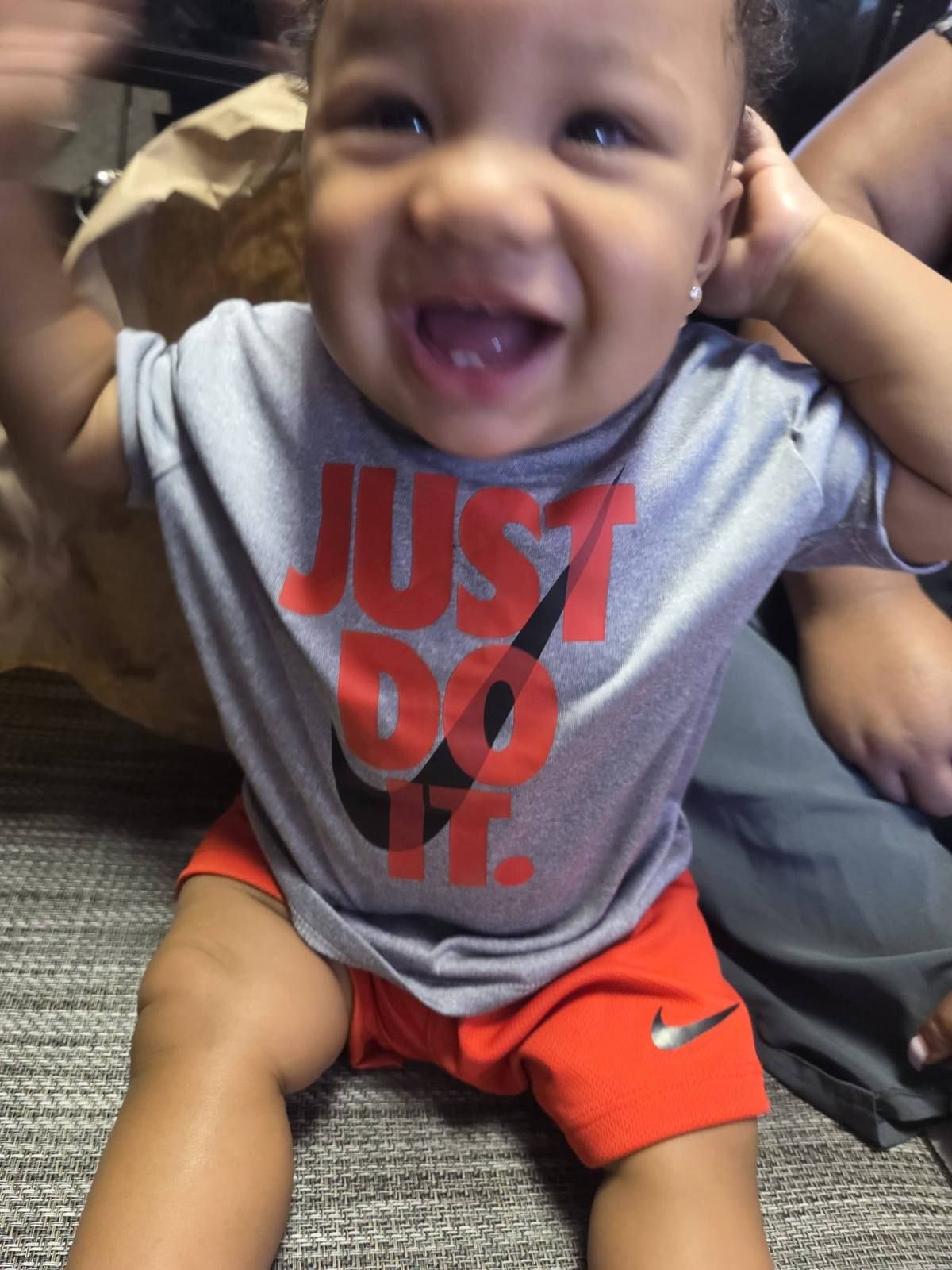 A giggling baby playing peekaboo