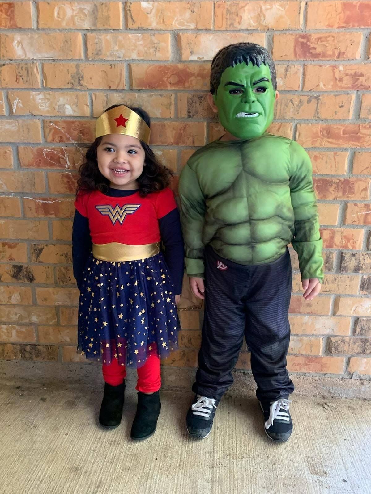 Two preschoolers dressed as superheroes for costume day