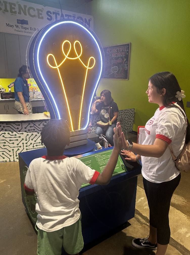 Kids exploring a science museum light exhibit