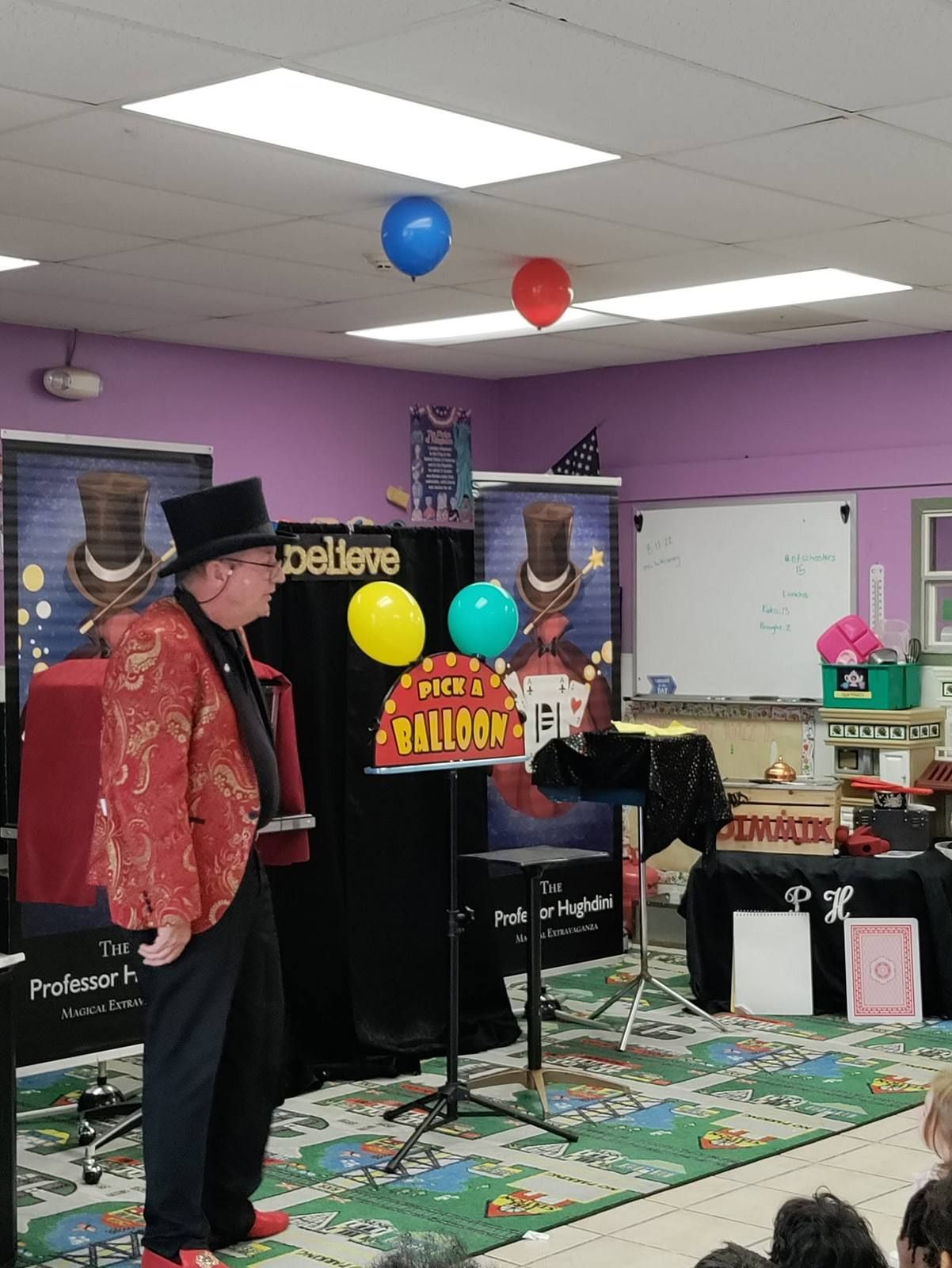 A magician putting on a balloon show in the classroom