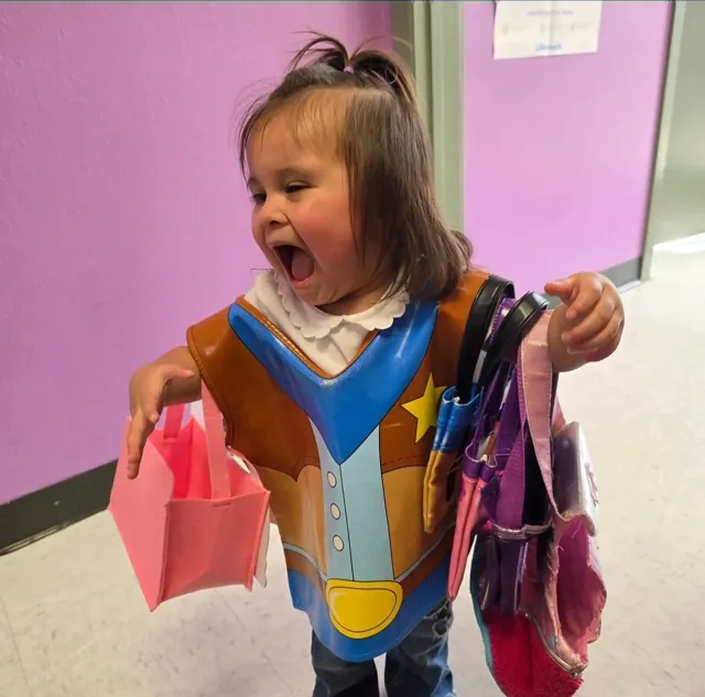 A toddler dressed up at Kidco